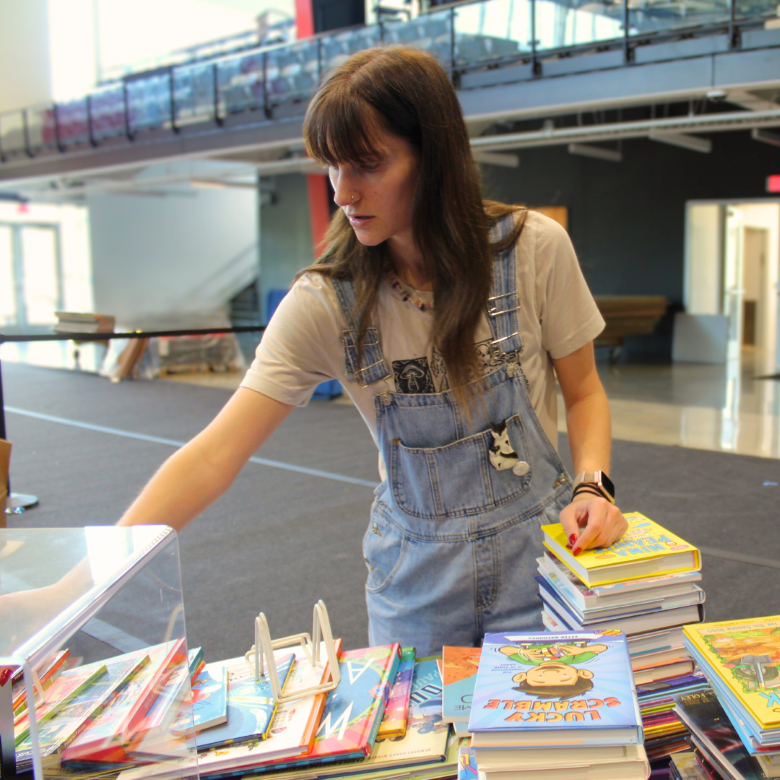 librarian arranging a display of book on a table