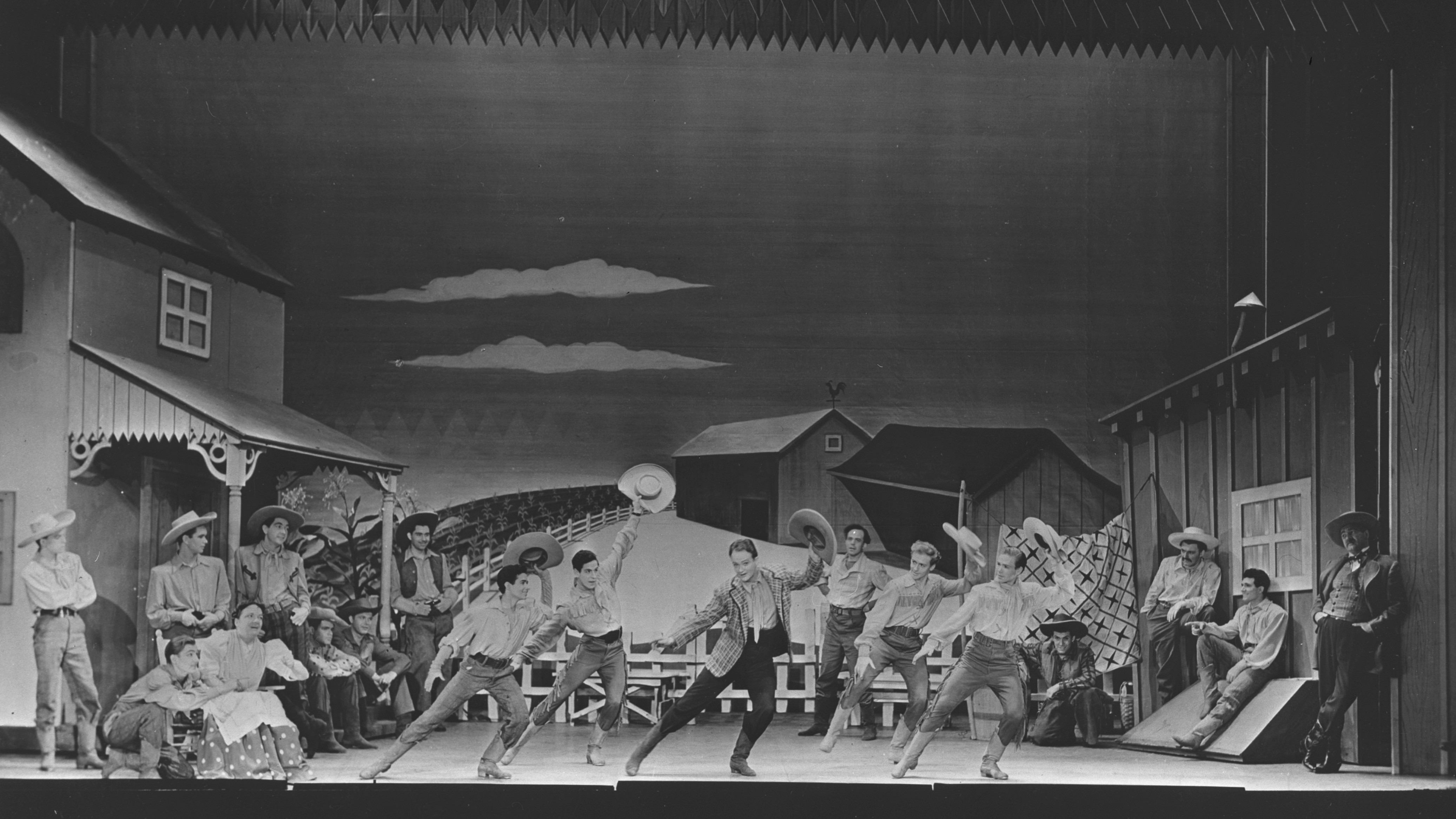 Image of a song and dance routine from a production of the musical Oklahoma, by Rodgers and Hammerstein, circa 1943.