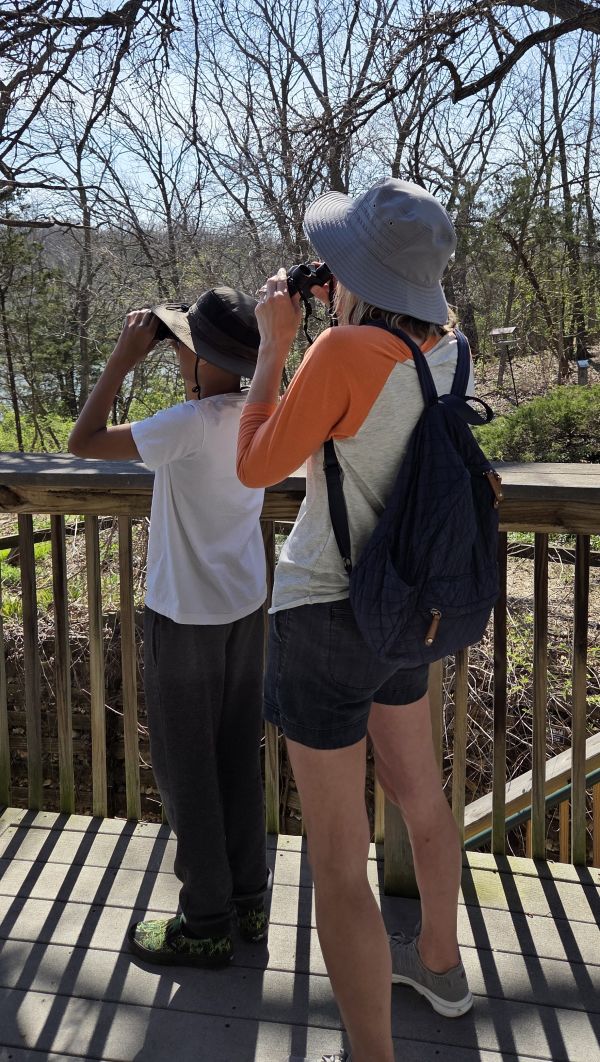 a mother an son using binoculars to look at birds on the deck of the Mr and Mrs F. L. Schlagle Library