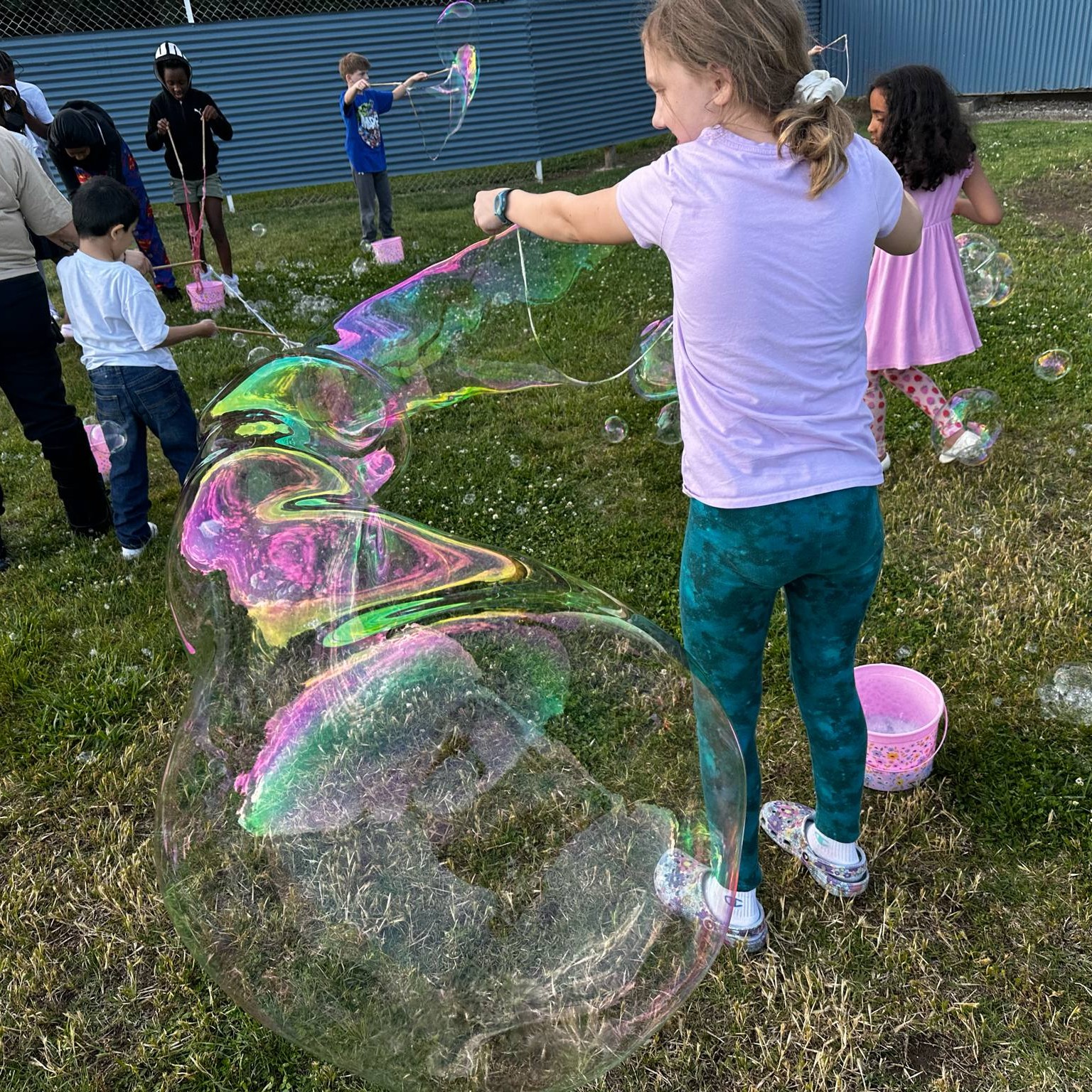young children playing with giant bubbles at summer reading kickoff party 2025