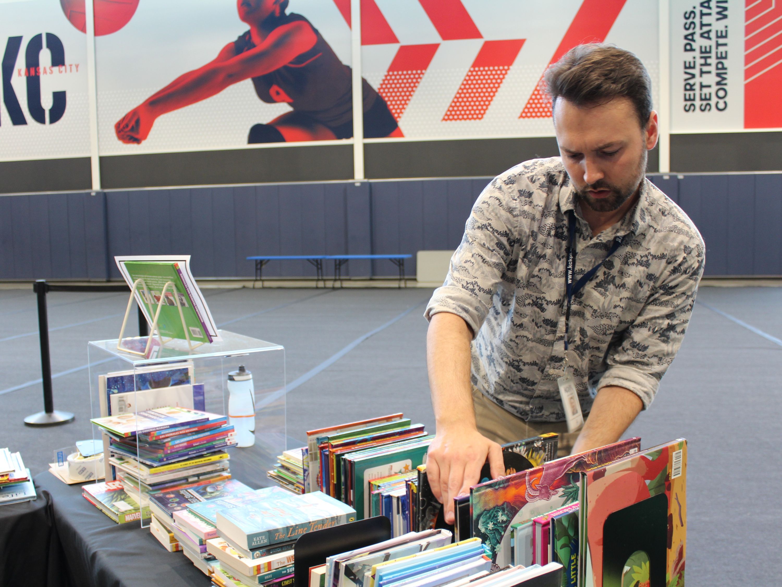 librarian arranging a display of book on a table