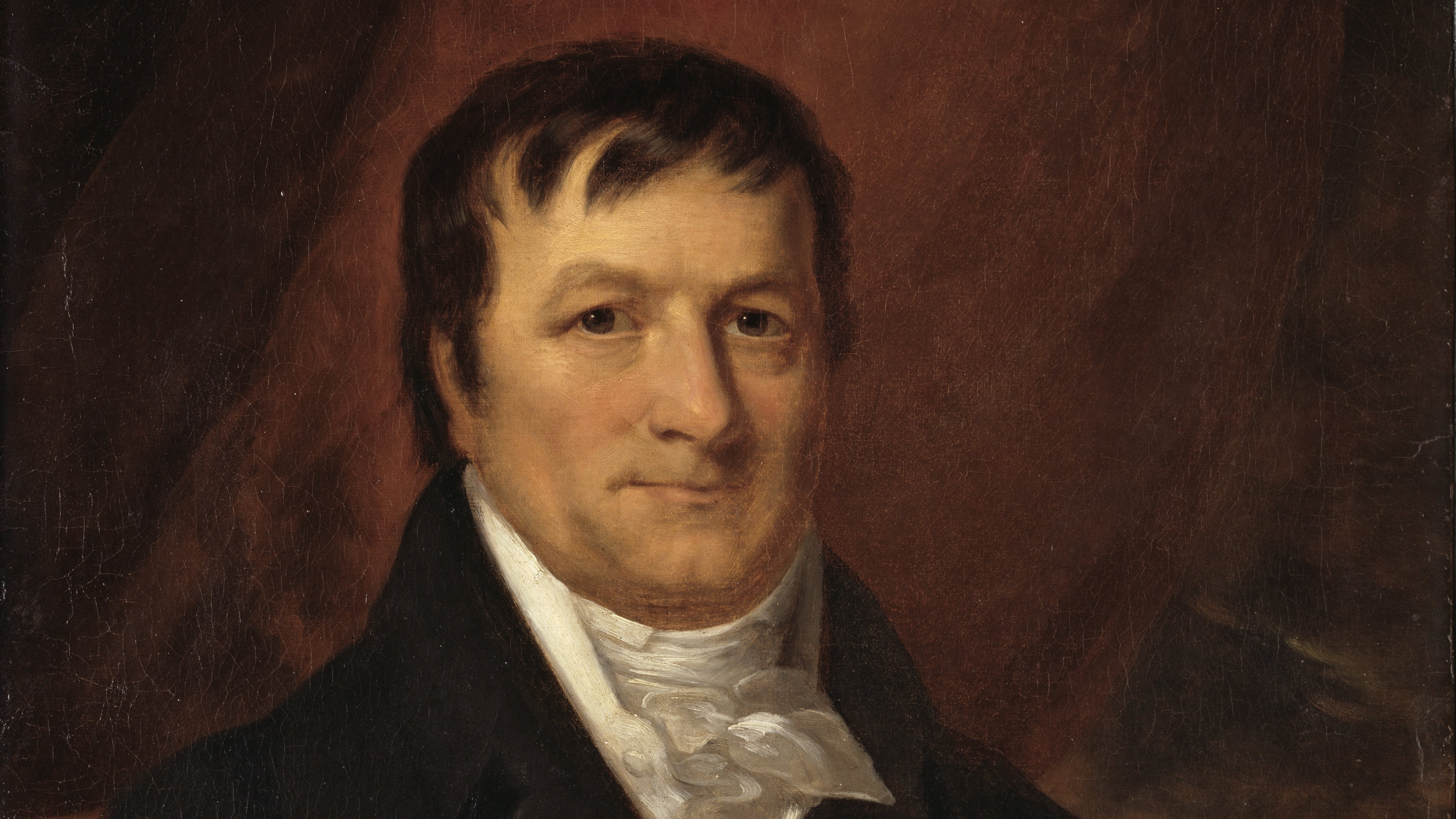 Portrait of John Jacob Astor by John Wesley Jarvis, circa 1825. He is a middle aged Caucasian man with short brown hair and a black suit.