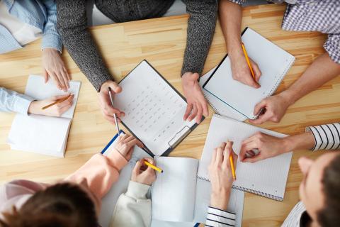 overhead view of students hands working on a table 