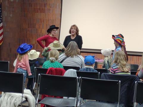 Jo with five kids acting out a story.