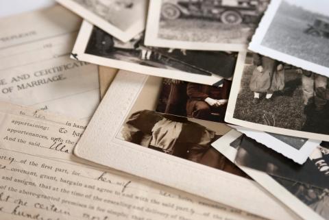 vintage photographs and papers spread out on a table