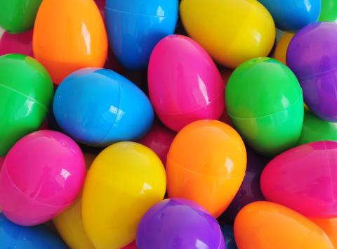 Close up of a pile of bright plastic Easter eggs of various colors