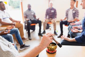 a group of people seated and meditating in a class