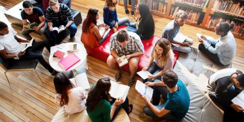aerial view of teenagers sitting on various couches and cushions in a library