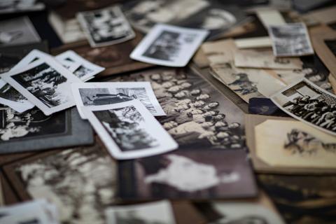 various historic and vintage photographs of people spread out on a flat surface