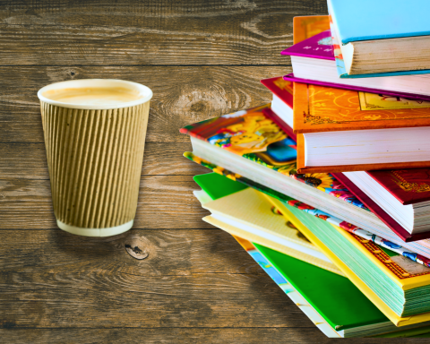 We see a delicious cup of coffee next to a pile of book representing our Storytime and Sips program.