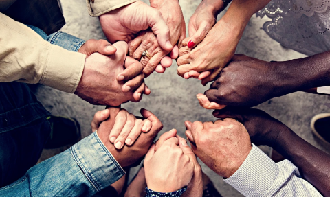 A circle of people holding hands.