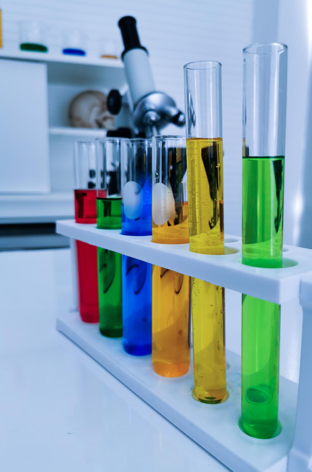 a science lab with a row of colorful test tubes.