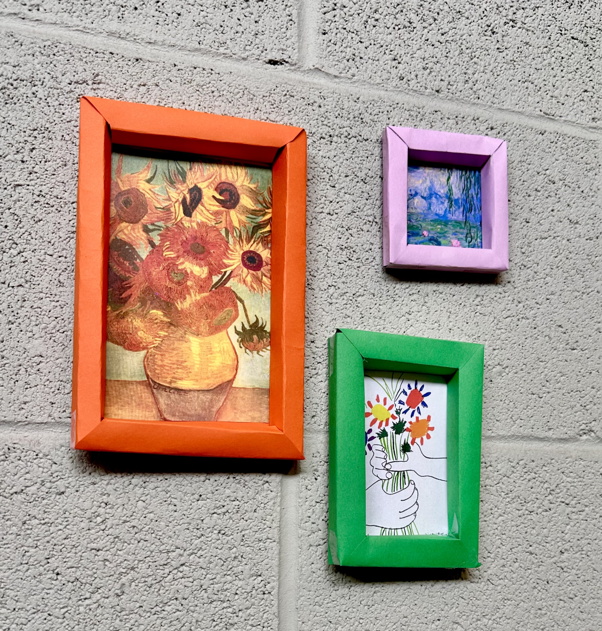 3 paper picture frames on a wall. 