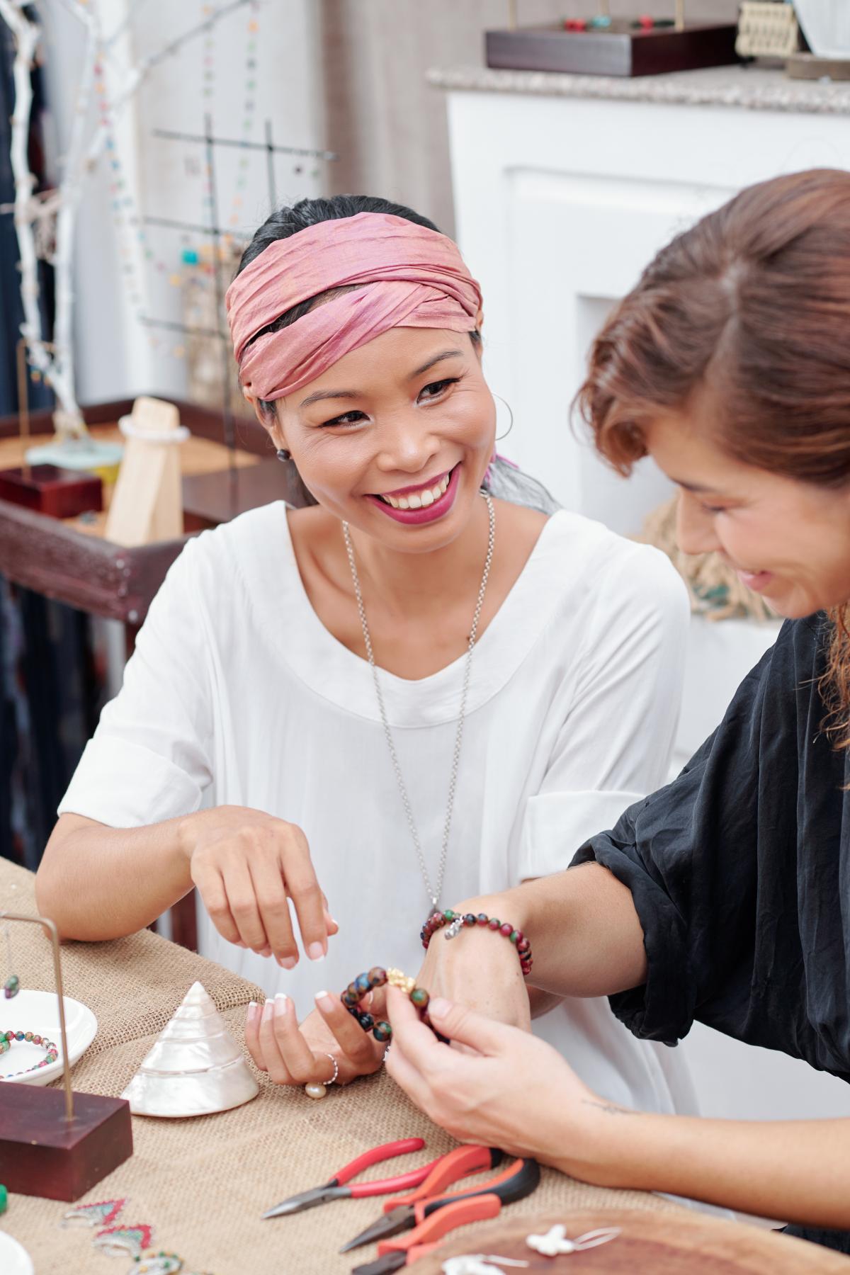 Two women enjoying making jewelry