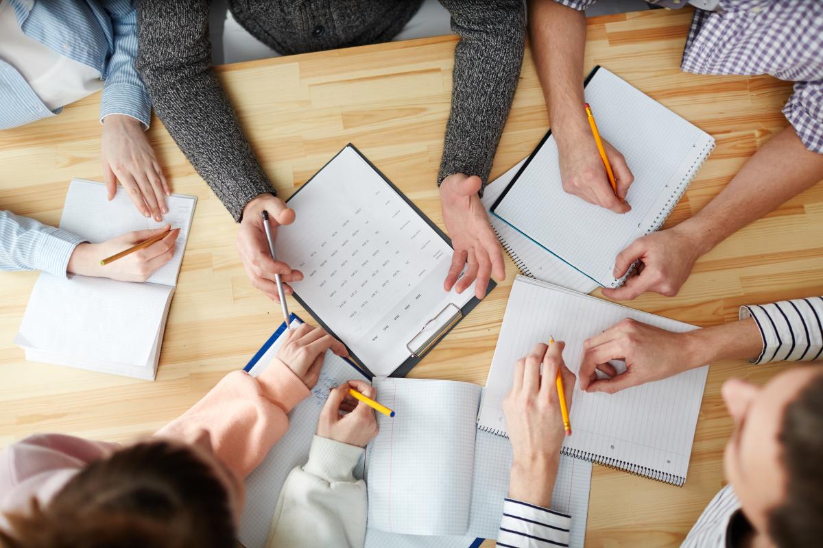 overhead view of students hands working on a table 