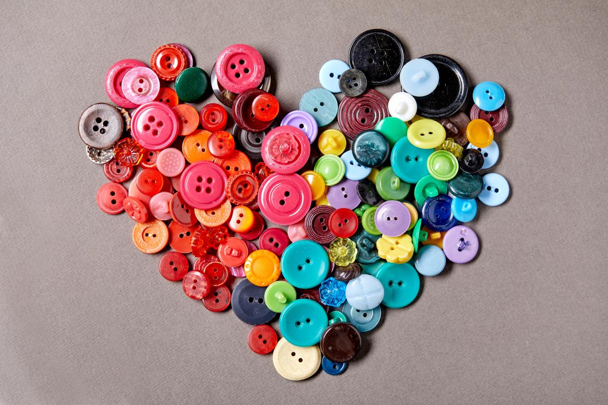 Colorful clothing buttons arranged in a heart shape