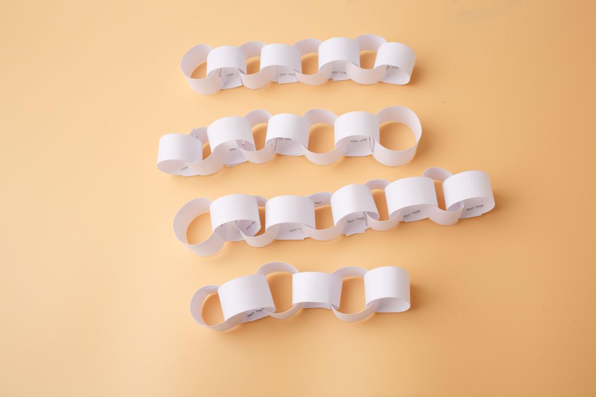 white paper chains laying on a table