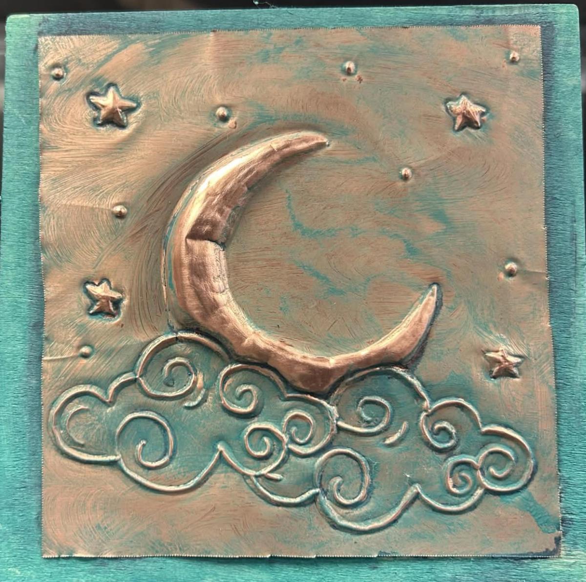 Embossed Copper Art. Copper molded into the shape of a crescent moon, clouds and stars.