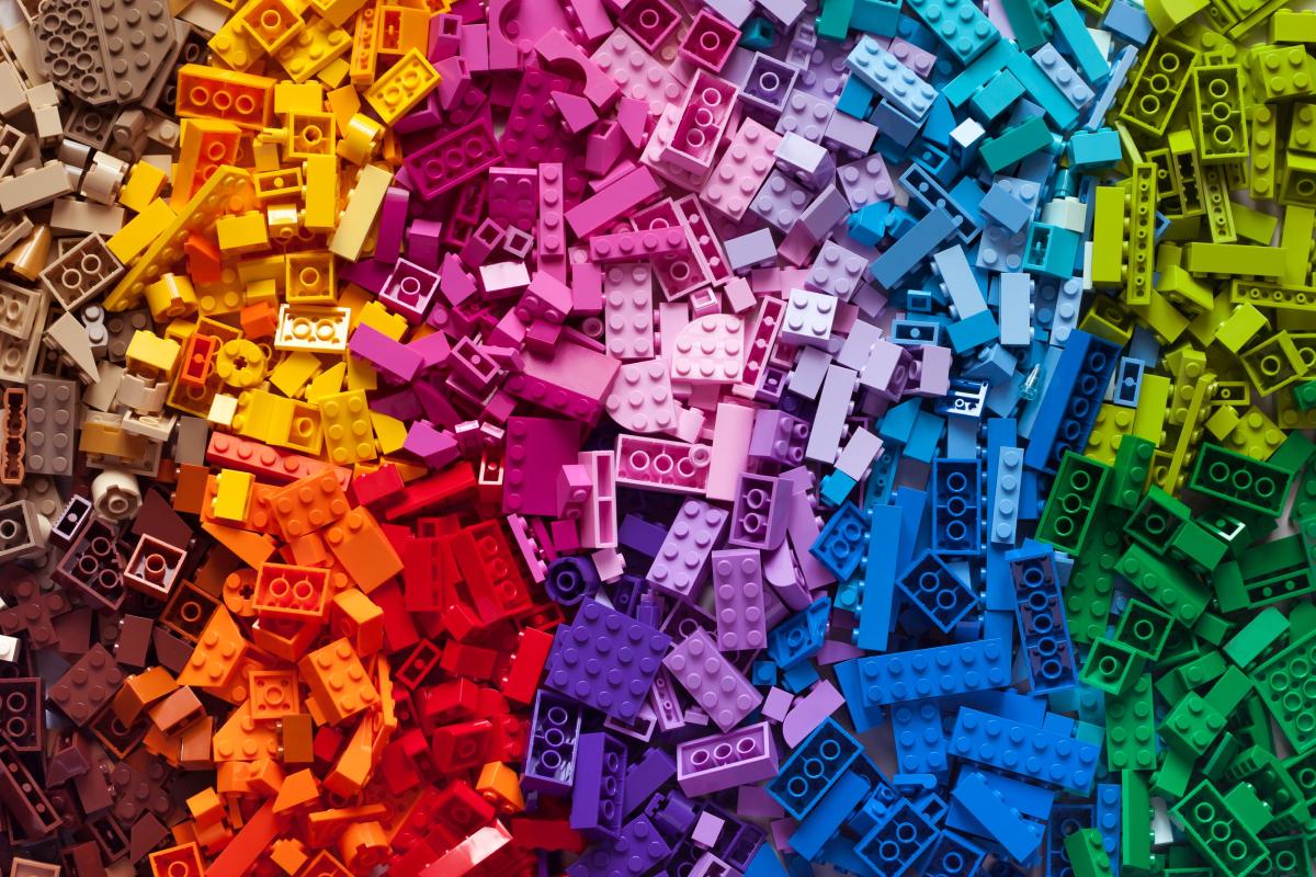 colorful Lego bricks laid out in a rainbow pattern