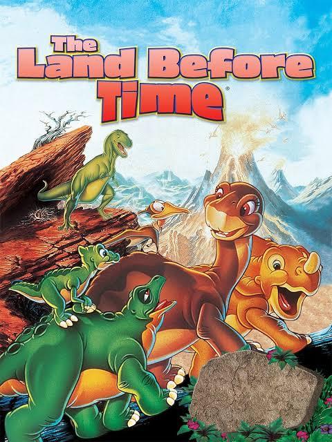 a group of different young dinosaurs with a volcano in the background