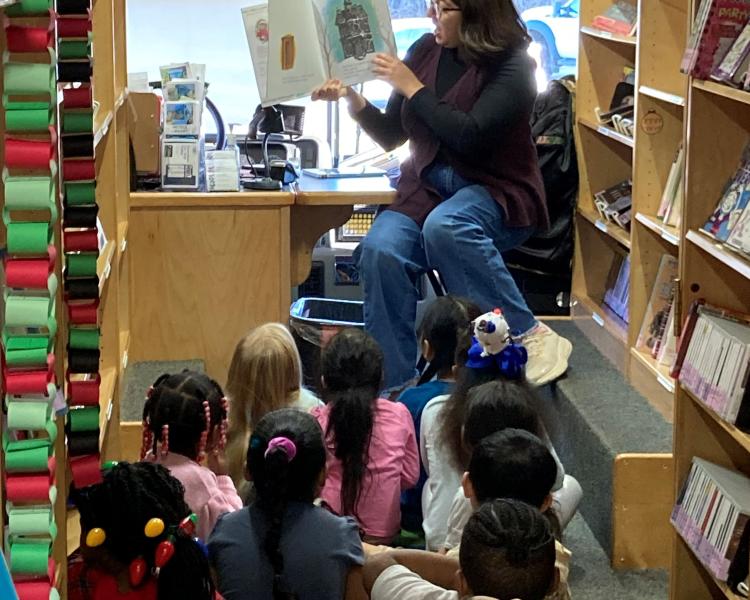 mobile library associates reading to kids on a KCKPL mobile library bus